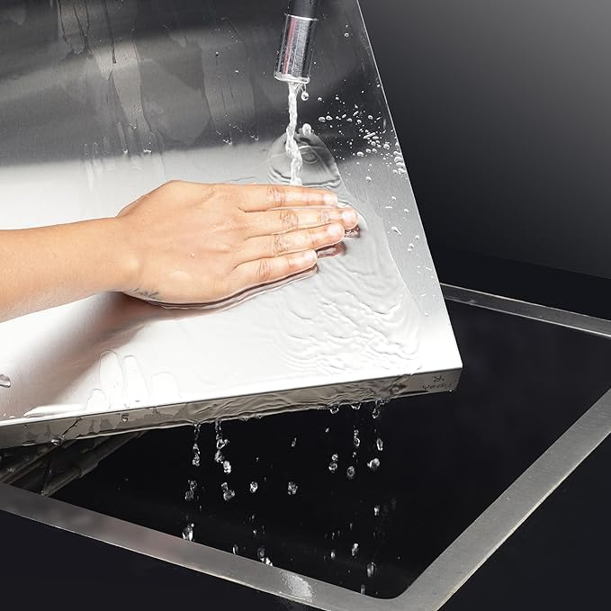 Hand washing under a faucet in a modern kitchen sink.