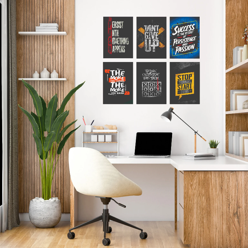 Modern home office with motivational posters on the wall, a desk, chair, and plant.