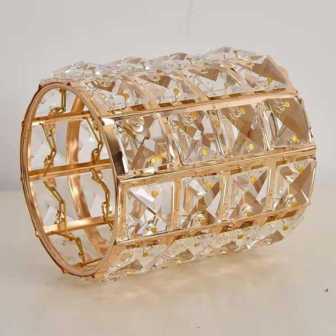 Decorative crystal box with gold accents on a light background
