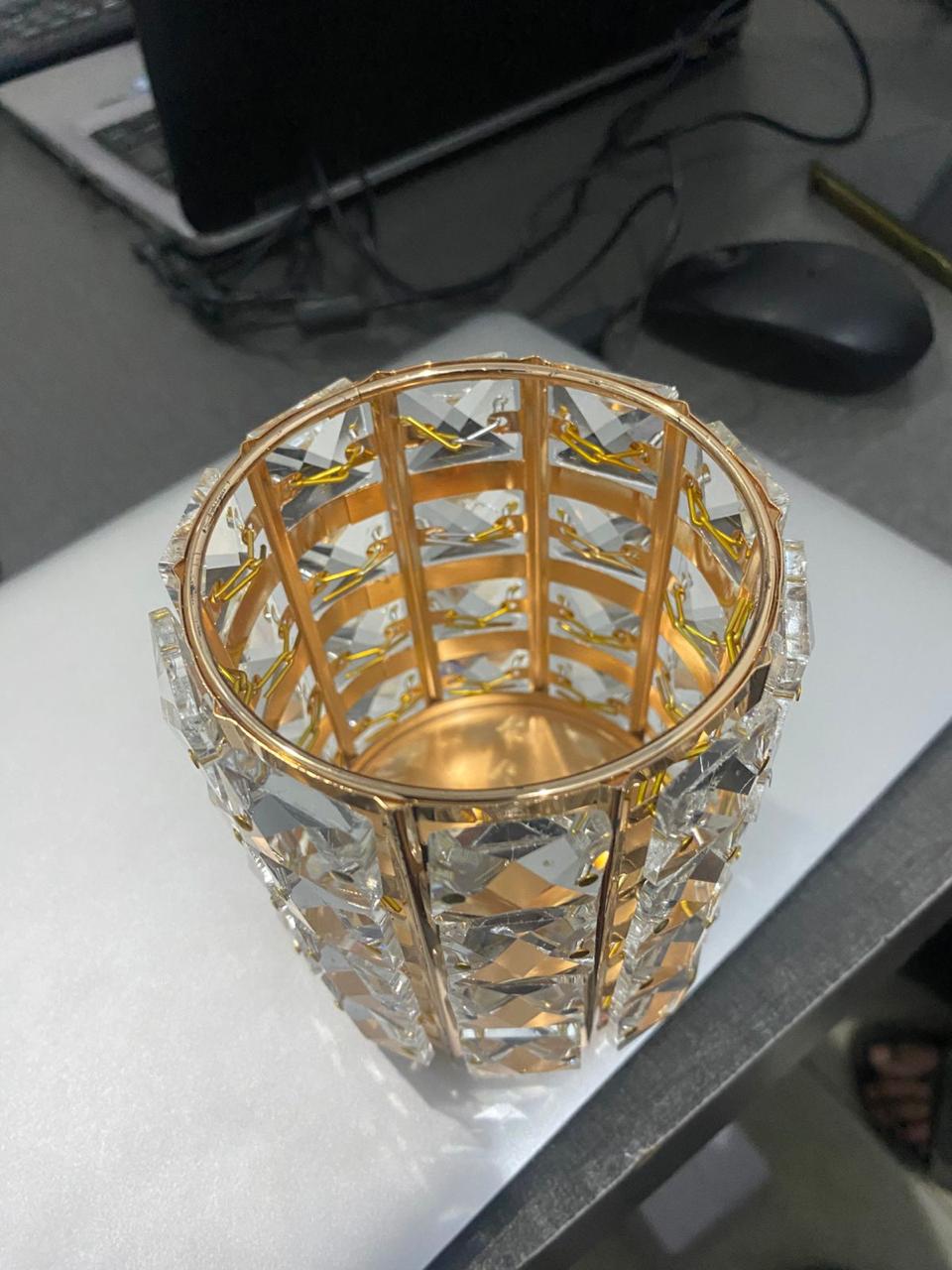 Decorative glass vase with gold rim on a desk