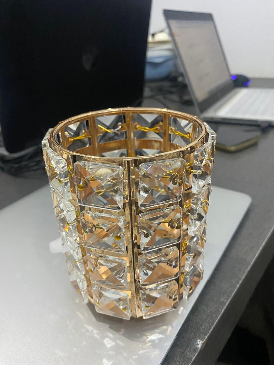 Decorative glass vase with gold accents on a desk