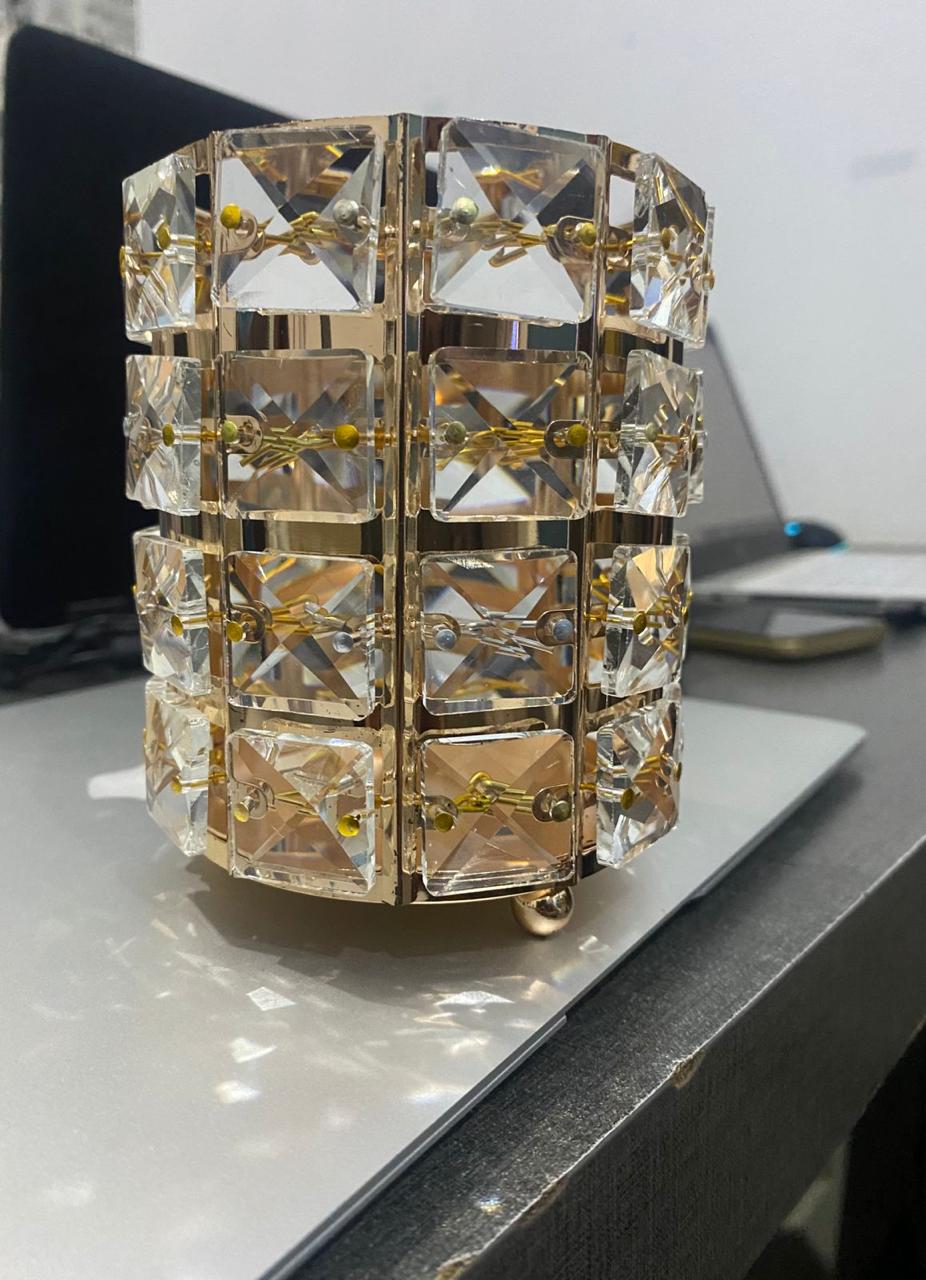 Decorative crystal candle holder on a surface with a blurred background