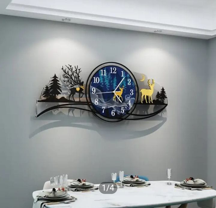 Decorative wall clock with deer and forest design on a gray wall above a dining table.