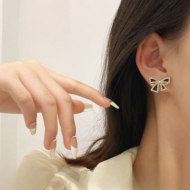 Elegant Zircon Bow Shape Earrings in Black and White with Gold Finish by Trend-ify