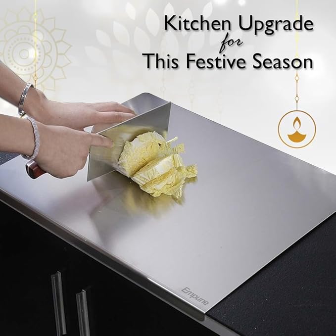 Person cutting cabbage on a large metal cutting board with 'Empire' branding, text 'Kitchen Upgrade for This Festive Season' above.