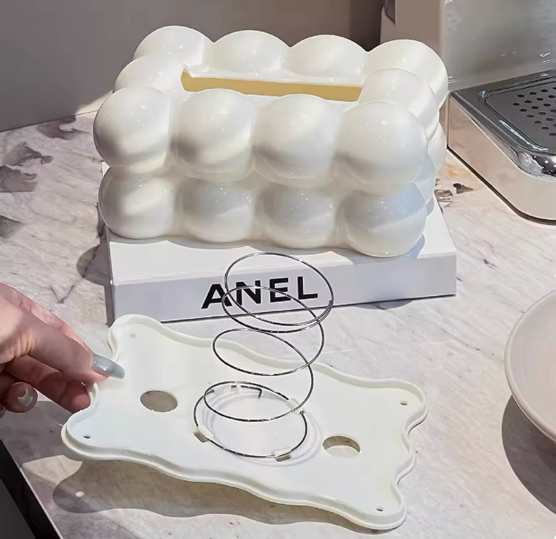 White egg-shaped container with a hand holding a clear object on a light-colored surface.