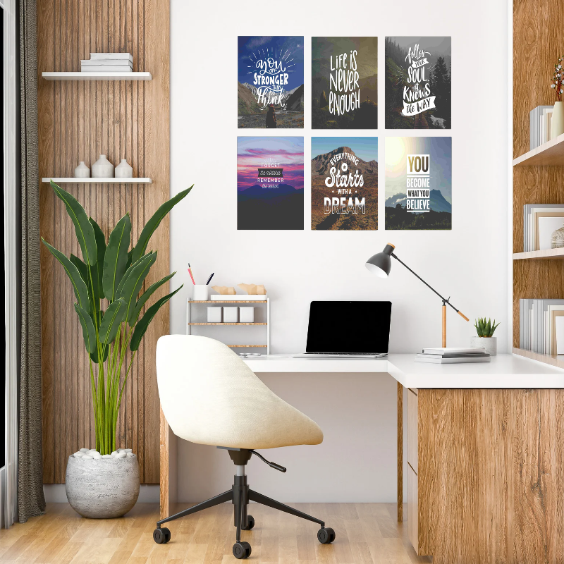 Modern home office with a desk, chair, and motivational posters on the wall.
