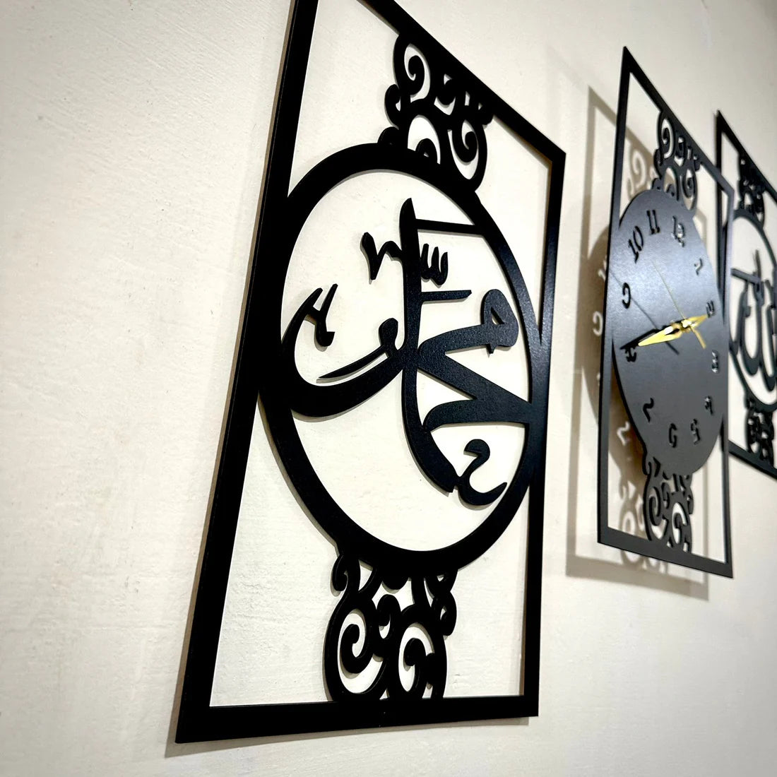 Decorative wall clock with intricate black metal design on a white wall